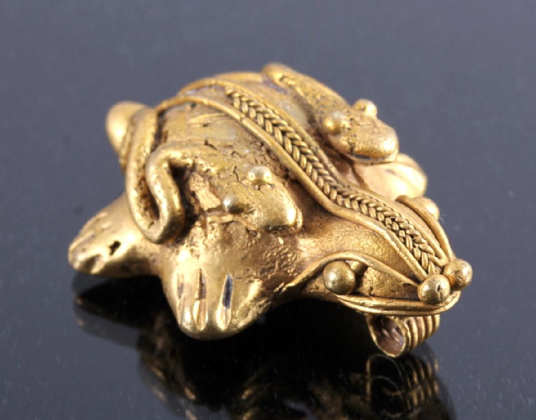 Tairona Gold Effigy Pendant 200-1600 CE: This is a Tairona gold effigy pendant from 200-1600 CE. The Tairona were a civilization in northern Colombia known for their metallurgy and agriculture. This pendant is a wonderful depiction of two sn
