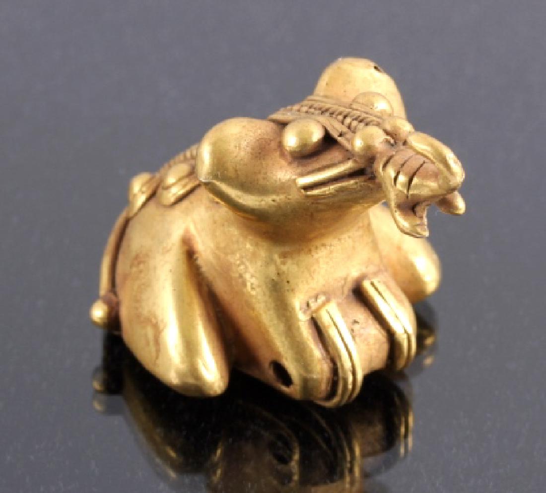 Tairona Gold Effigy Pendant 200-1600 CE: This is a Tairona gold effigy pendant from 200-1600 CE. The Tairona were a civilization in northern Colombia known for their metallurgy and agriculture. This pendant is a depiction of a frog and has b