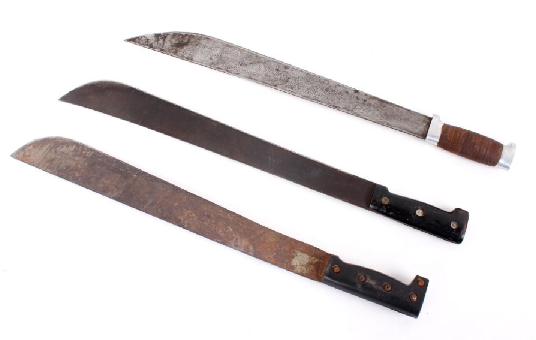 Vintage Machete Collection: This lot features three machetes of various types. The first is a machete marked "Made in Sheffield England". These machetes were used in WW II by British and American troops. It has darkened with age