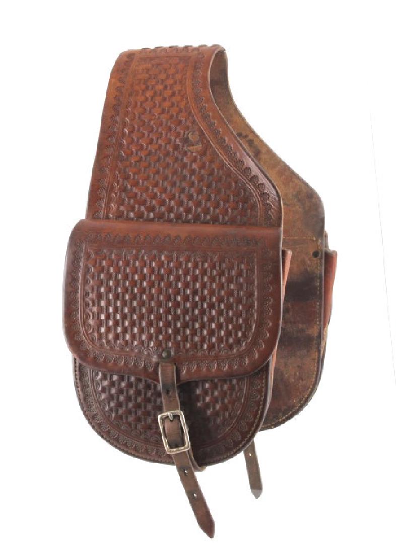 Tooled Leather Western Saddlebags: This is a set of tooled leather Western saddlebags. The saddlesbags show a beautiful hand tooled basket weave pattern with a decorative stamped border. Each side is joined by stitched leather at the t