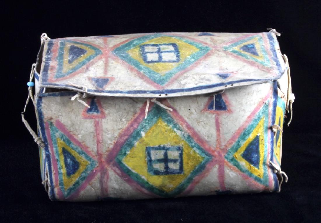 Plains Polychrome Parfleche Trunk: The lot features a Plains Native American Indian attributed or style parfleche rawhide truck showing a traditional geometric polychrome painted pattern. The piece has a very rough manufacture showing 