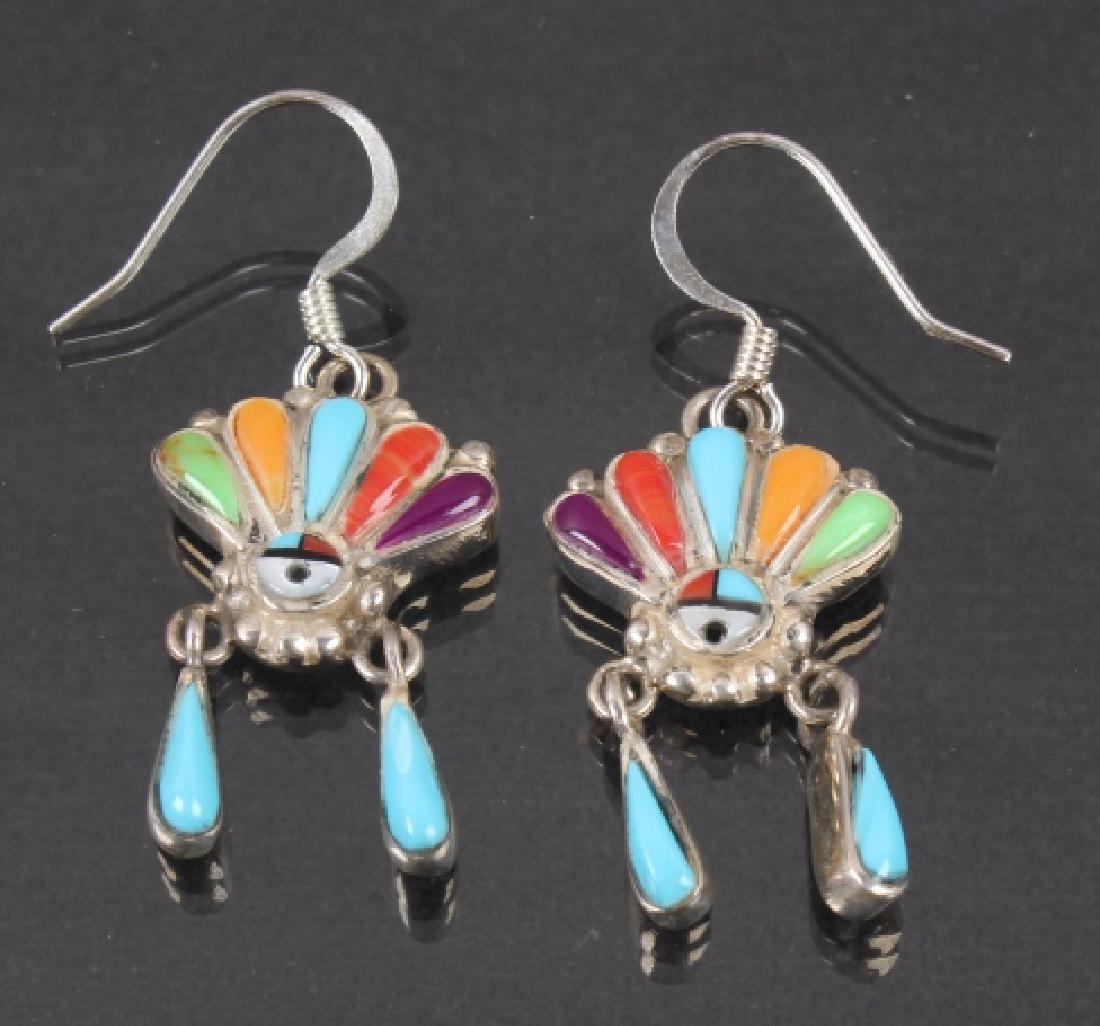 Navajo Ornate Earrings: For sale in this lot we have two Navajo Native American earrings inlayed with an assortment of stones. The earrings are sterling sliver inlayed with sleeping beauty turquoise, sugilite, mother of pear