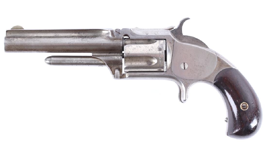 Smith & Wesson Model 1 1/2 2nd Issue .32 Revolver: For bidding in this lot is a Smith & Wesson second issue, Model 1 1/2 revolver, chambered in .32 Rim Fire. The 2nd issue is identified by its fluted barrel and cylinder, as well as its rounded grip-bu