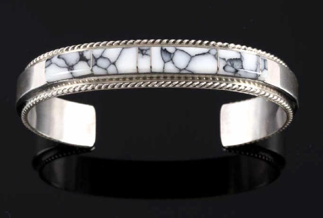 Fran Yazzie Navajo White Buffalo Turquoise Cuff: For bidding in this lot is a signed Fran Yazzie, Navajo Native American Indian cuff, or bracelet. The piece is crafted of heavy sterling silver, and shows a striking band of white buffalo turquoise la