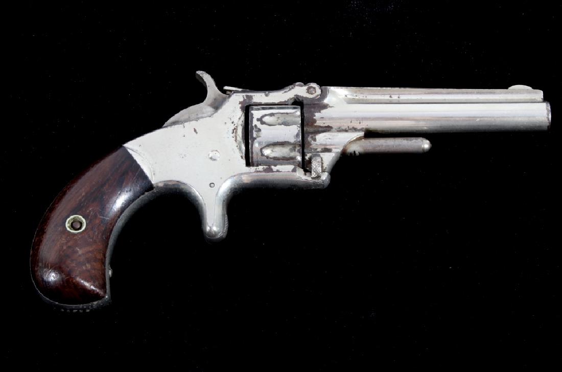 Smith & Wesson Model 1 3rd Issue Revolver c1868-81: The lot features a Smith & Wesson Model Number 1 Third Issue variation chambered in .22 RF (rimfire). The revolvers shows a serial number of 130813 and was manufactured from circa 1861 to 1881. The re