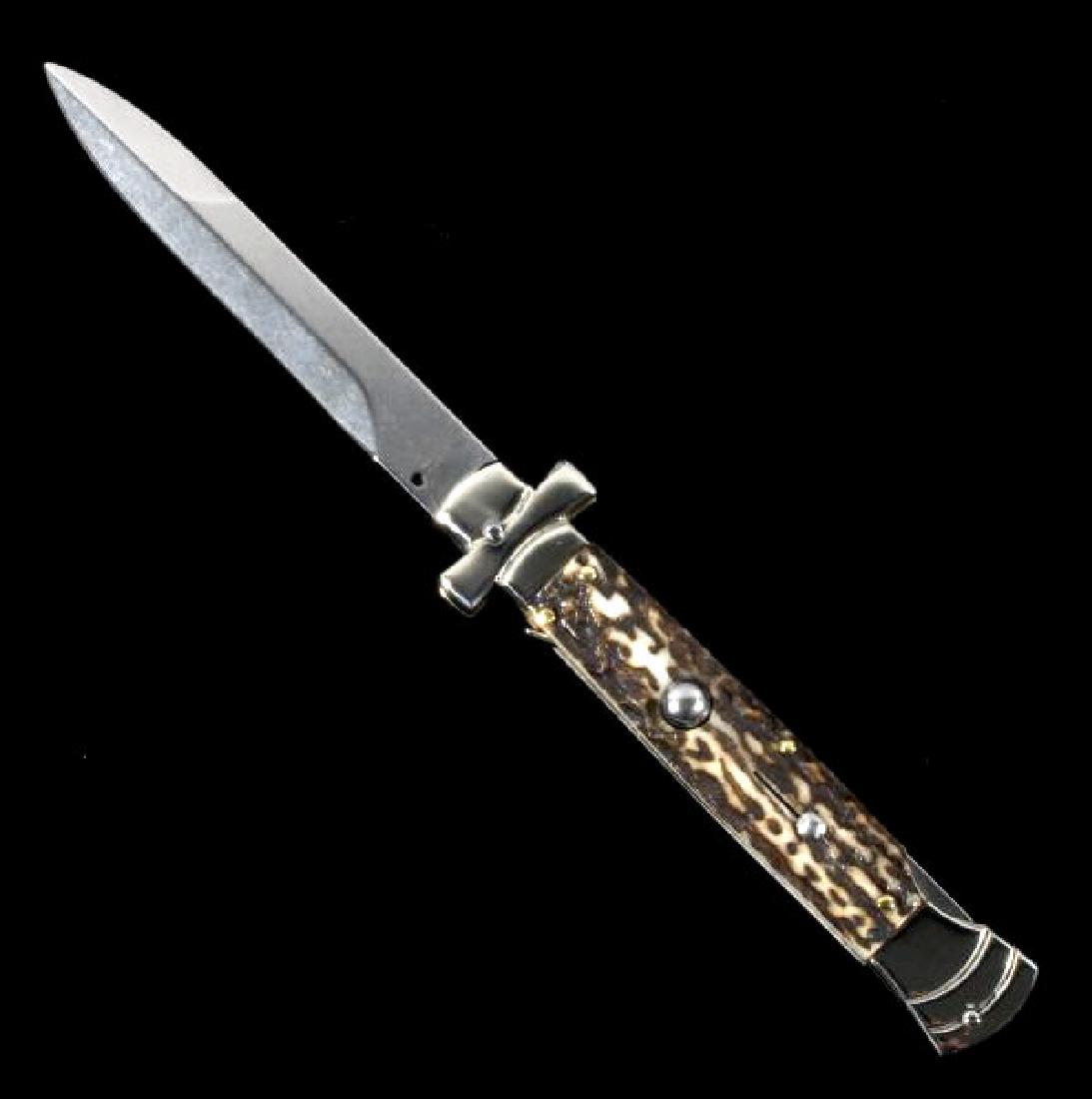 Campolin Maltese Cross Italian Switchblade Knife: This is a Campolin Italian made Maltese Cross stiletto switchblade knife. The knife features the Maltese Cross hilt and stag horn grips with a push button to release the blade. The blade is marked "A.