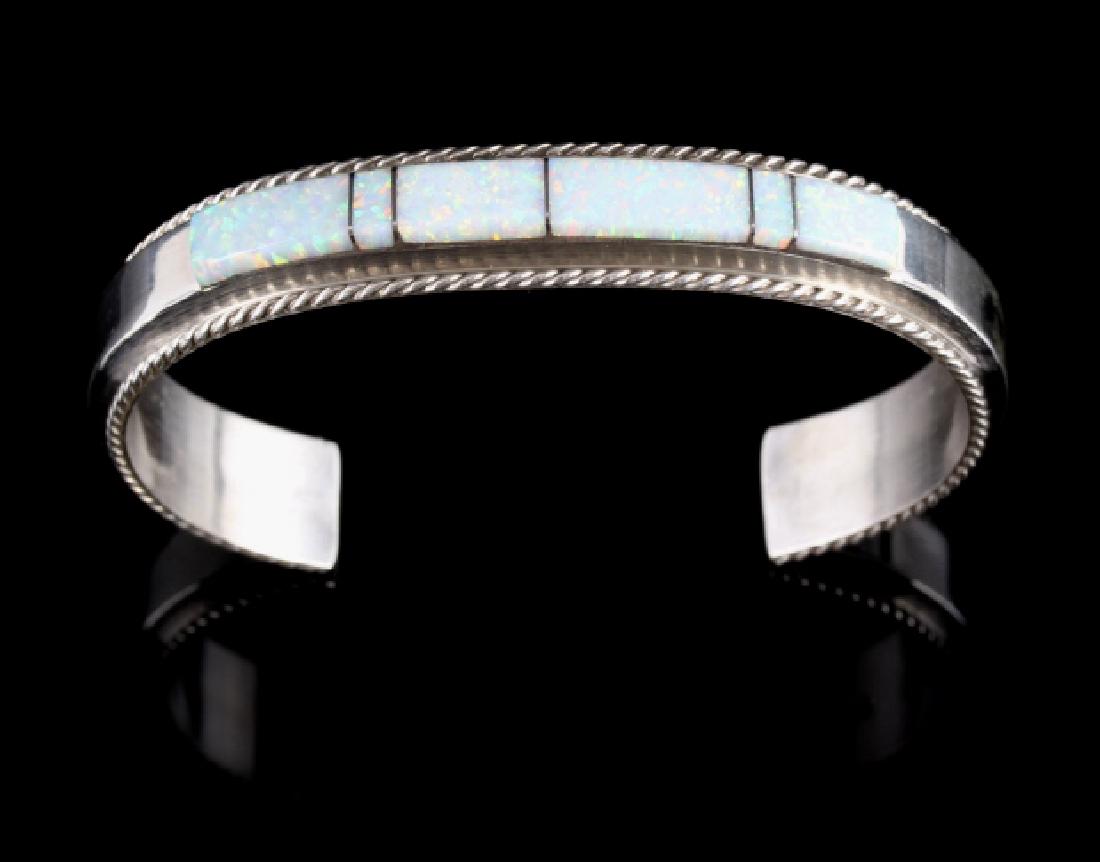 Fran Yazzie Navajo Inlaid White Opal Sterling Cuff: For bidding in this lot is a signed Fran Yazzie, Navajo Native American Indian cuff, or bracelet. The piece is crafted of heavy sterling silver, and shows a striking band of white opal laid across the