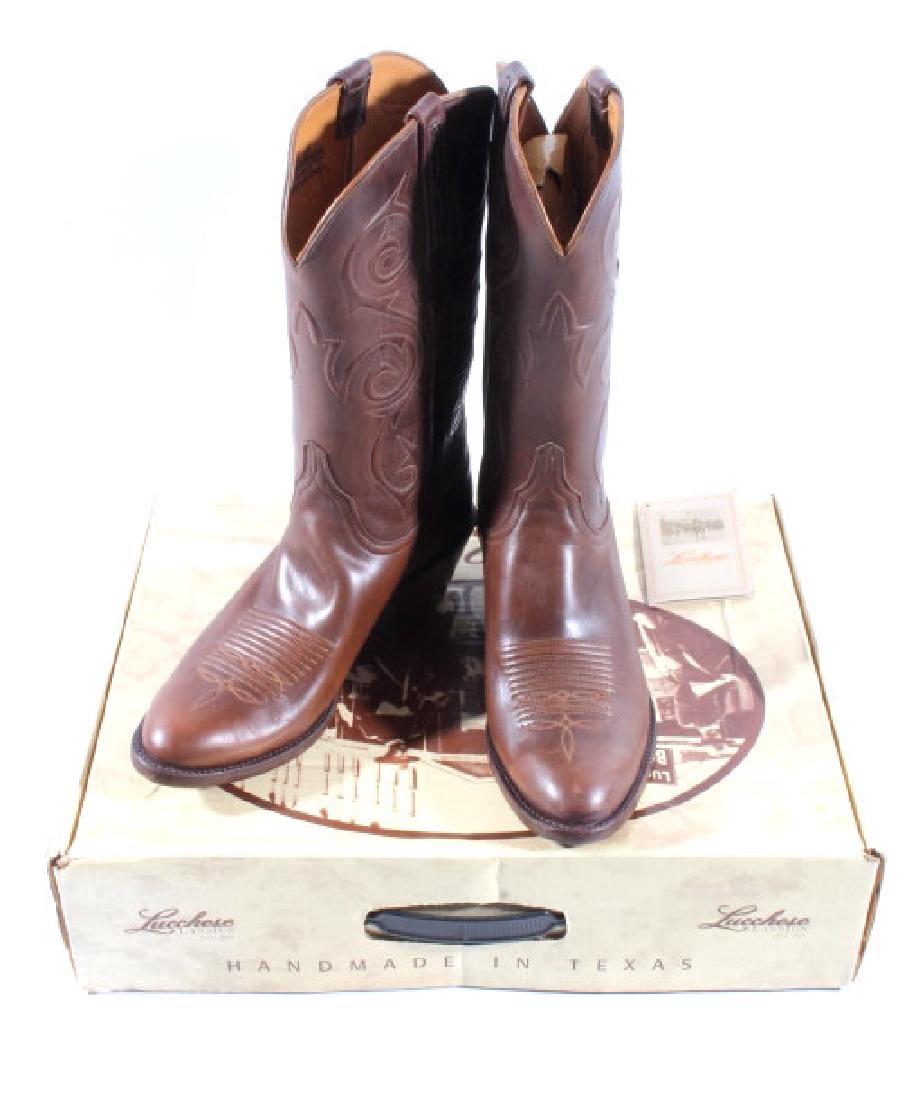 Lucchese Classic Calfskin Cowboy Boots: Included in this lot is a new pair of In Box Lucchese Classic cowboy boots size men's 9. The boots are handcrafted in Texas out of genuine leather, and feature a classic Western stitching pattern, wit