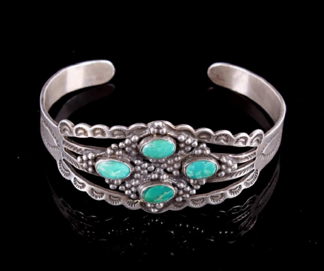 Navajo Old Pawn Style Silver & Fox Turquoise Cuff: This is an Old Pawn Sterling Silver bracelet or cuff circa 1920's. The piece is hallmarked, "STERLING". The piece shows four Fox Turquoise mine style gem quality cabochons on a heavy worked/tooled ste