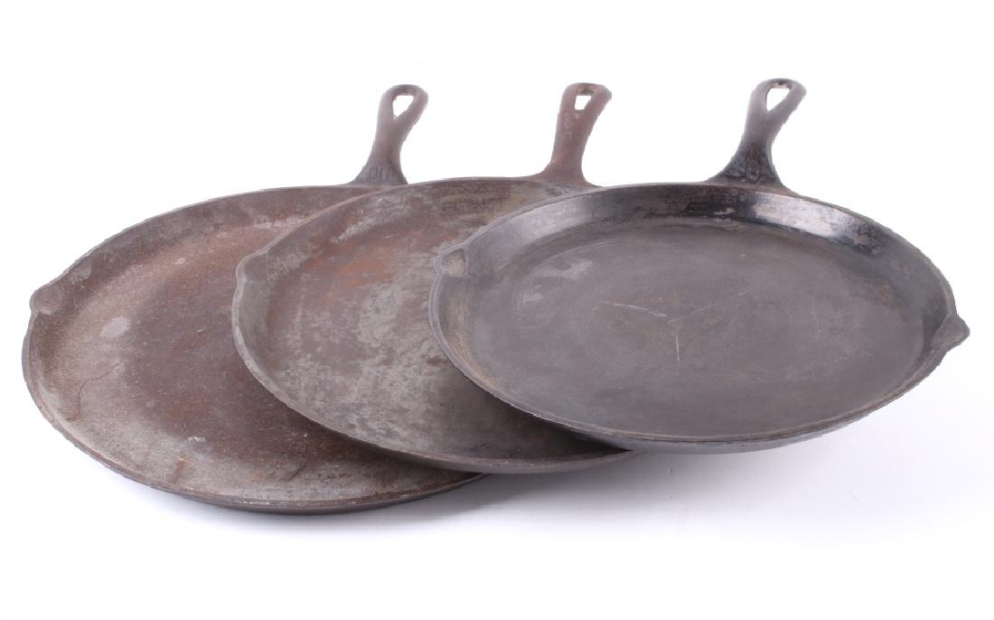 Griswold Antique Cast Iron Skillet Griddle Set (3): Featured in this lot is a set of three Griswold cast iron skillet griddles: nos. 108, 109, and 110. The no. 108 is marked "CAST IRON SKILLET GRIDDLE-108-THE GRISWOLD MFG. CO.-[GRISWOLD LOGO]- ERIE PA 