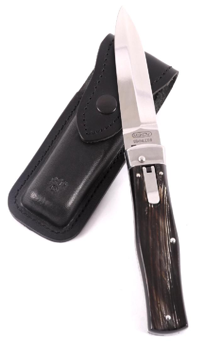 Mikov Czech Republic Steer Horn Switchblade: Offered for sale in this lot is a Mikov black steer horn gip switchblade knife. The knife utilizes a stainless dagger blade, and lever-lock action. The blade is marked "MIKOV - Stainless" on one side,