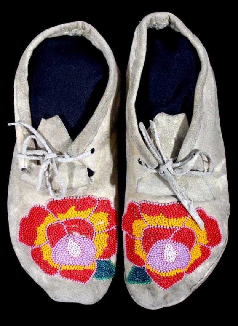 Cree Indian Floral Beaded Moccasins c. 1900-1930's: This is a fabulous set of authentic original Cree Native American Indian floral beaded moccasins from circa early 1900. The set shows an Indian tanned hide construction with wonderful typical Cree moc