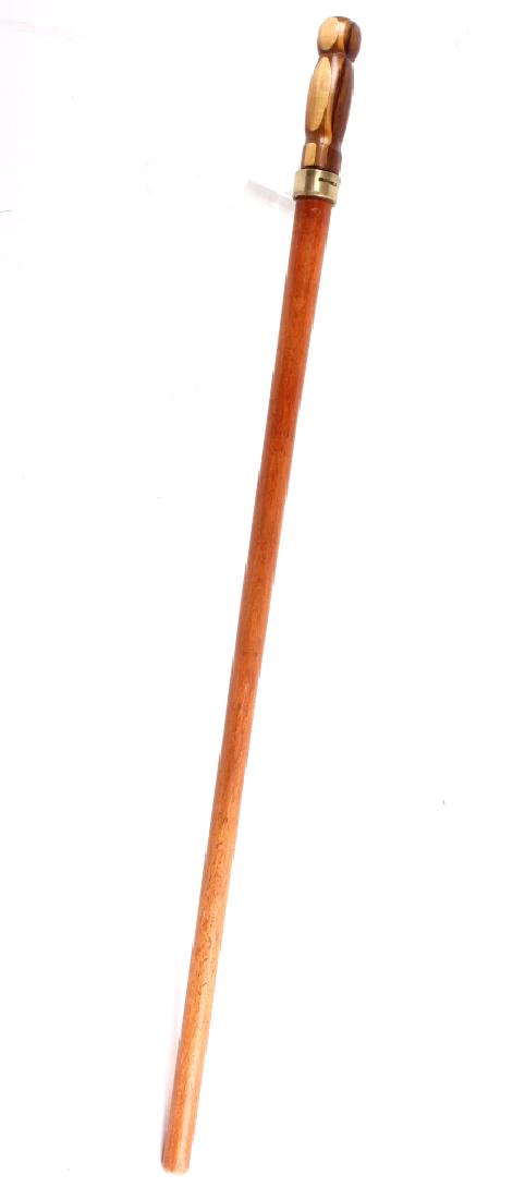 Wood Twist Collar Cane-Sword: Featured in this lot we have a Wooden twist collar cane-sword. The cane is made of a single piece of stained maple shaft with a brass twist collar at the top. The dagger handle is made of layered mapl