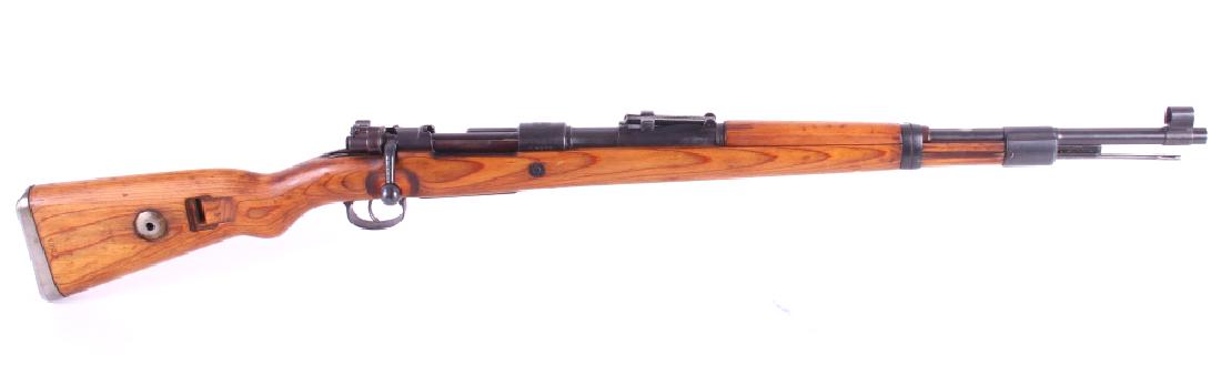 Yugoslavian Model 98 Mauser Bolt Action Rifle: For auction in this lot is a Yugoslavian Model 98 Mauser Bolt Action Rifle, chambered in 8mm. The rifle utilizes a hardwood stock, a blue'd finish, straight-pull bolt - with flag safety, adjustable la