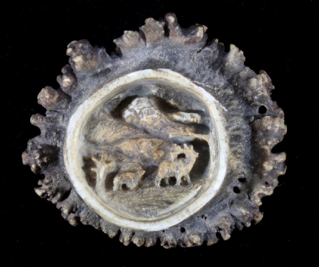 Carved Mountain Scene Elk Burl Belt Buckle: Featured in this lot we have a elk burl belt buckle with a hand carved elk in mountains landscape scene. The face of the buckle shows the carved image of a bull elk and cow elk moving between trees in