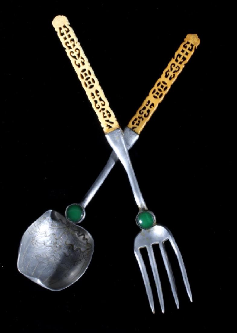 Chinese Aluminum and Bone Serving Spoon and Fork: For your consideration in this lot we have a pair of Chinese silver and bone serving spoon and fork. The utensils are made of Aluminum with the handles made of bone. Each of the pieces show a single p
