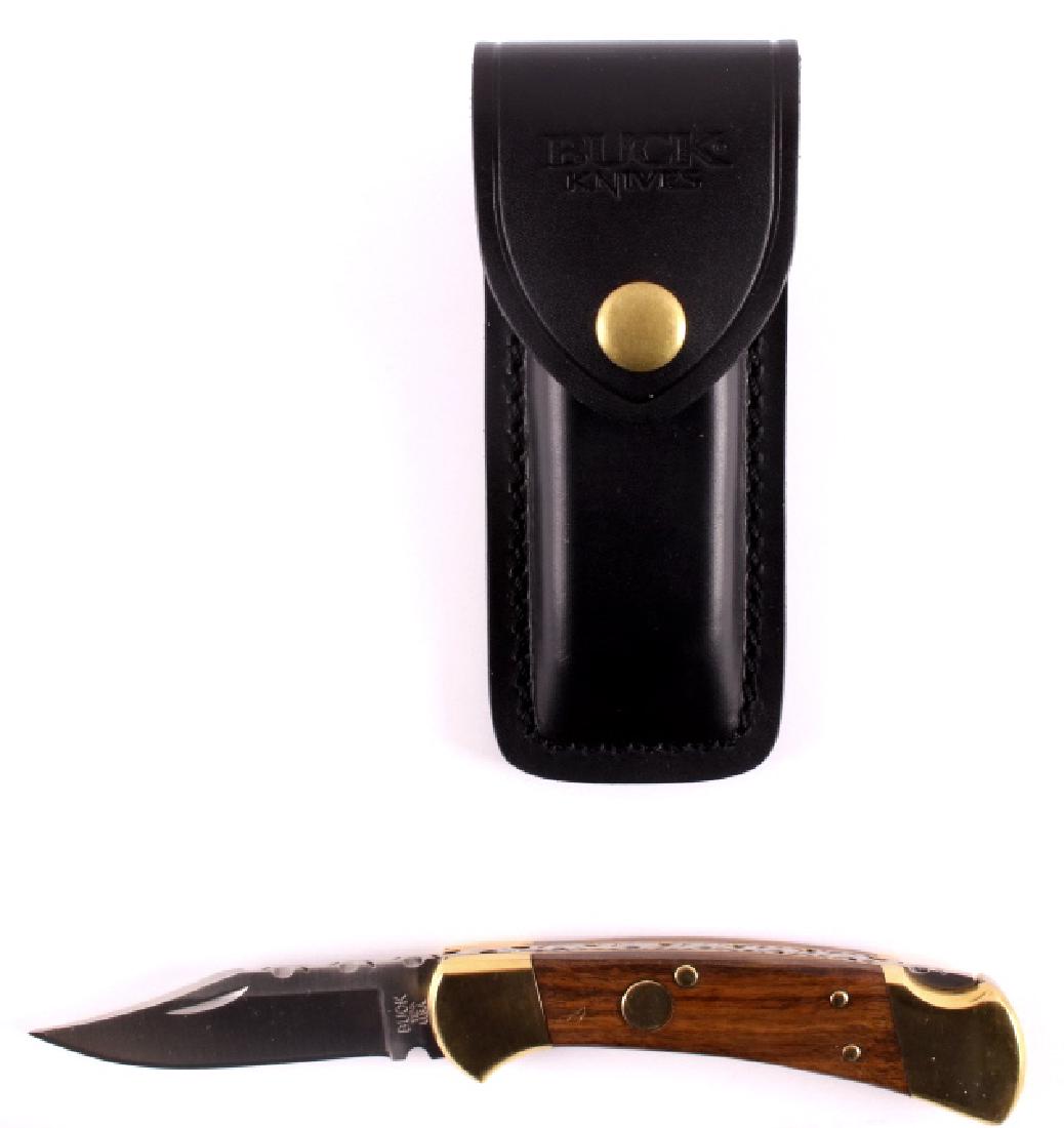 Buck 112 Custom Switchblade Knife w/ Scabbard: This is a Buck 112 Custom switchblade knife with leather scabbard. The knife features a hardened steel clip point blade marked "Buck 112 U.S.A.". The handle has brass bolsters with solid hardwood grip