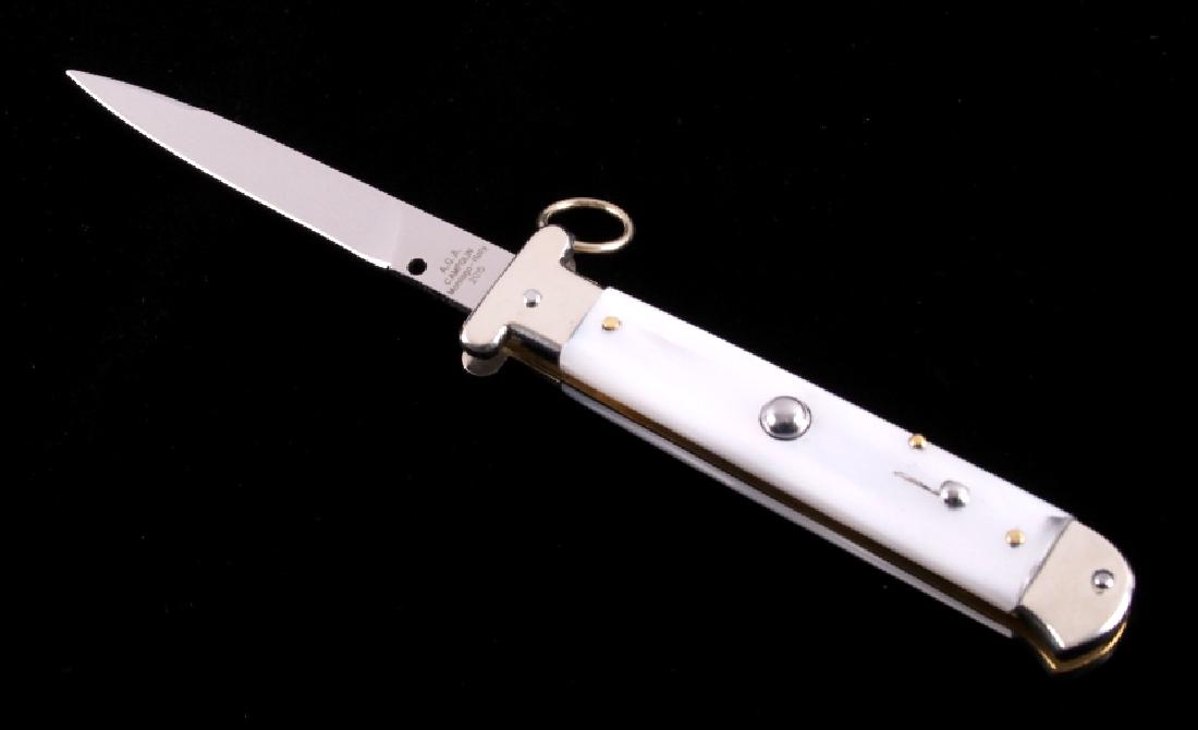 Campolin Italian Ring Pull Stiletto Switchblade: This is an Italian made Campolin ring pull stiletto switchblade knife. The knife has a stainless steel blade marked "A.G.A. Campolin Maniago Italy 2015" and features a pearlescent celluloid handle. Th