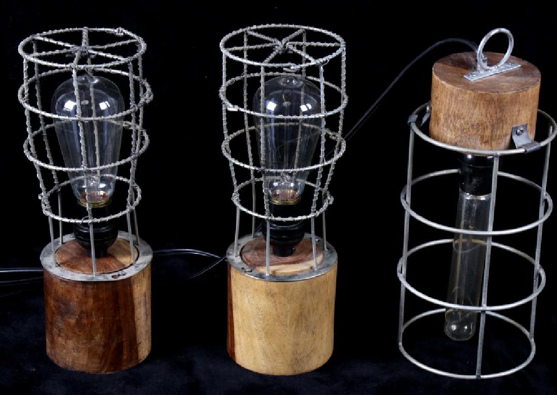 Three Industrial Style Lamp With Edison Bulb: Featured in this lot we have a set of three industrial style modern lamps with Edison bulbs. Two of the lamps are end table or mantle lamps, and the last one is a hanging lamp. The pieces are made of