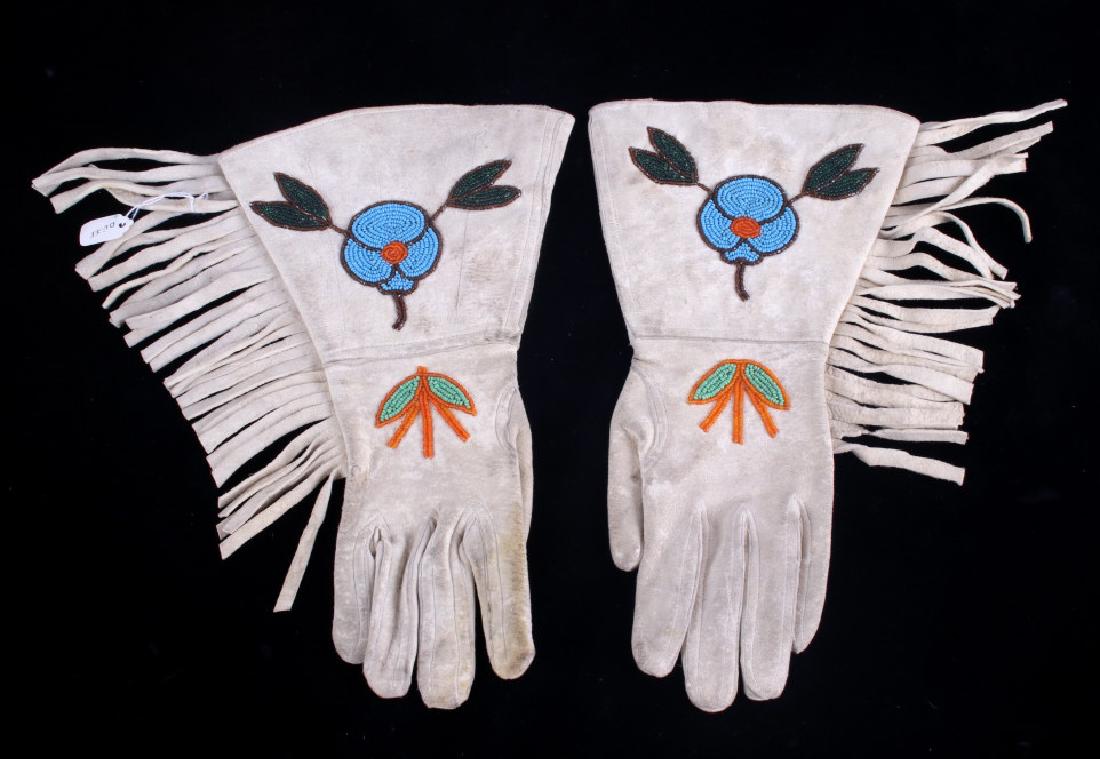 Montana Crow Floral Beaded Gauntlet Gloves 1950's: Offered for sale in this lot is a wonderful set of gauntlet gloves from the Crow Native American Indians of Montana and date to circa 1950's. The set shows an Indian tanned hide construction with spot