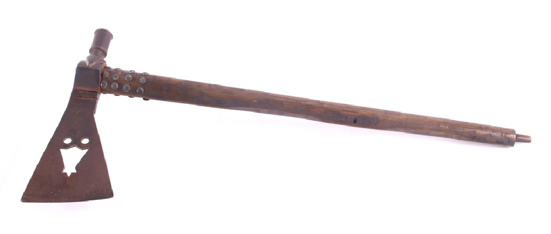 Batwing Cutout Pipe Tomahawk Indian Replica: The lot features a batwing cutout pipe tomahawk replica done in the styling of the Blackfoot (Blackfeet). The piece shows a cast head with two pierced holes and a batwing cutout with an added acid pat