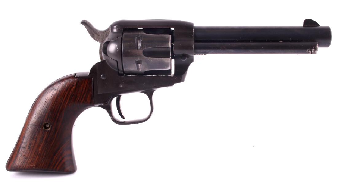Colt Single Action Frontier Scout .22 LR Revolver: This is a Colt Single Action Frontier Scout revolver in the .22LR caliber. The revolver features a blue'd barrel, frame and six shot cylinder with Cocobolo hardwood grips. The barrel is 4.75" and is m