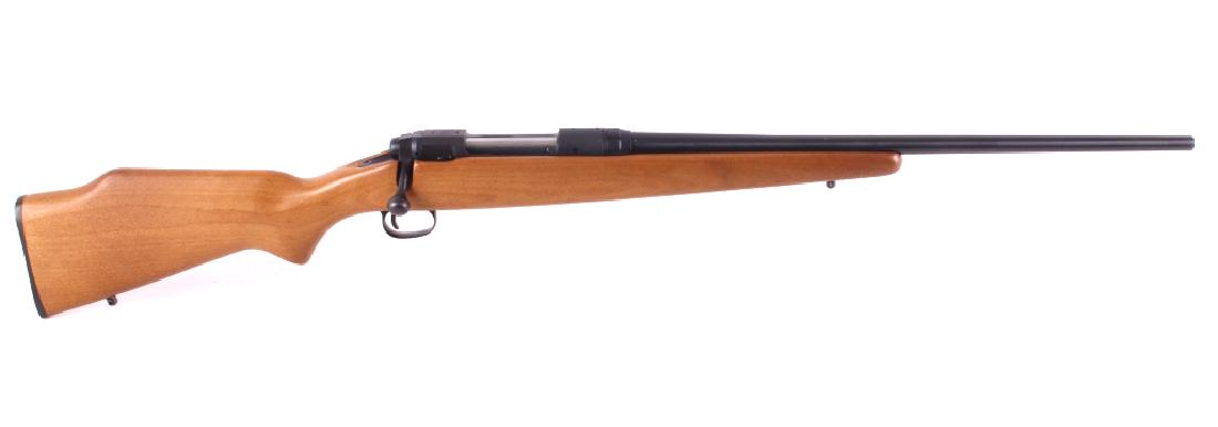 Savage Model 110E .243 Win Bolt Action Rifle: This is a Savage Model 110E bolt action rifle chambered in .243 Win. The rifle features a round blue'd steel barrel and receiver with a solid hardwood stock. The left side of the 22" barrel is marked 