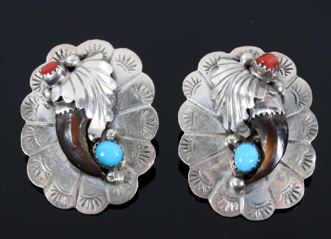 Navajo Silver Turquoise & Coral Bear Claw Earrings: Included in this lot we have a Navajo Native American sterling silver turquoise and coral bear claw earrings. The pieces shows a bear claw with a turquoise and coral nugget set into each earring. The 