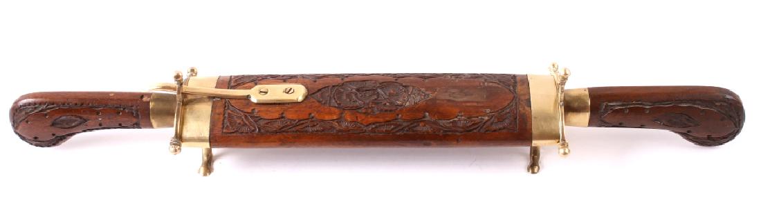 Vintage Two Piece Knife and Fork Carving Set: Available in this lot is a vintage two piece knife and fork carving set. This set comes in a unique hand carved Walnut wooden sheath with brass hardware. The blade is marked "India" and the set is in