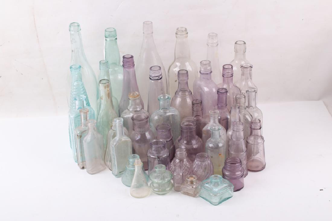 Collection of Vintage 1920's Depression Glass: For your bidding pleasure a is this Collection of Vintage 1920's Depression Glass. This collection is extensive with eighteen purple colored bottles, eleven blue bottles, and twenty two clear bottles.
