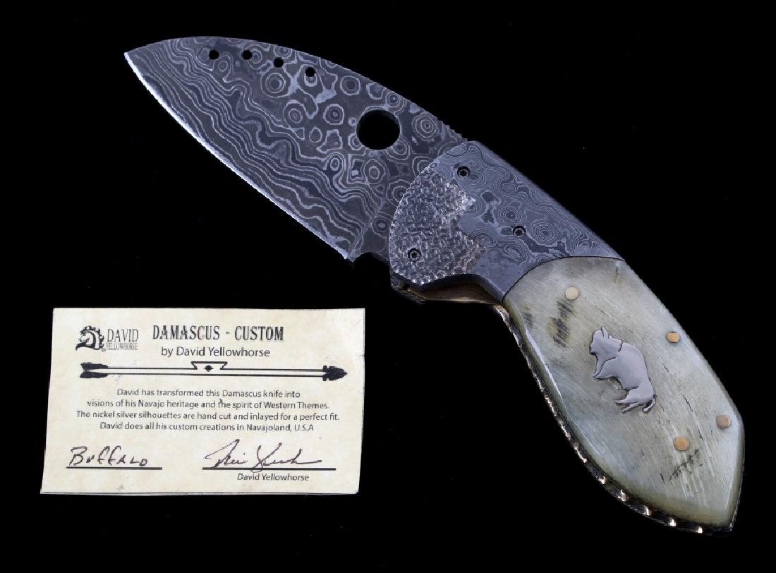 Navajo David Yellowhorse Damascus Buffalo Knife: We are proud to be one of the exclusive knife makers to offer David Yellowhorse custom Damascus pocket knives. The knife shows a set of highly polished Rocky Mountain Rams Horn grips with Silver Buffa