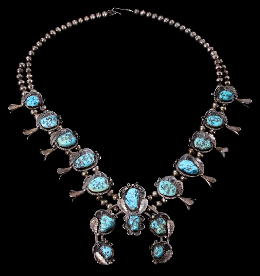 Navajo Sleeping Beauty Turquoise Squash Blossom: For your consideration is a singed Navajo Sleeping Beauty Squash Blossom necklace. This fine piece shows a large central Naja pendant, flanked on both sides by five blossoms. Each charm of the necklac