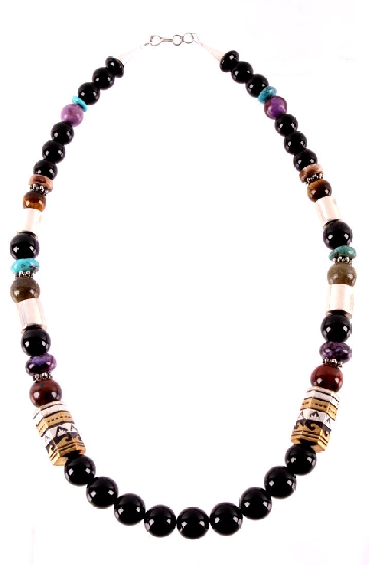 Navajo T&R Singer Multi Stone Necklace: For your bidding pleasure is a Navajo Native American T&R Singer multi stone necklace. This signed necklace features a string of onyx, sugalite, tiger eye beads. The necklace tipped with marked sterli