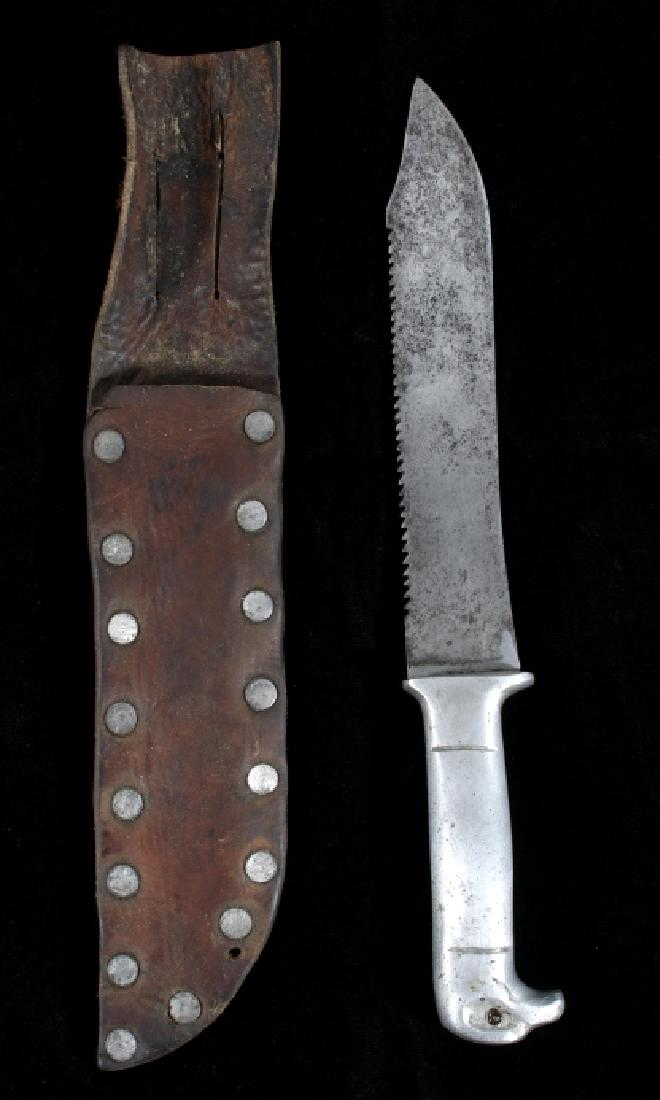 WWII Eagle Head Trench Fighting Knife with Sheath: Included in this lot we have a World War II trench fighting knife with eagle head pommel and leather sheath. The knife shows a steel bowie style blade with saw teeth along the back. The handle is made