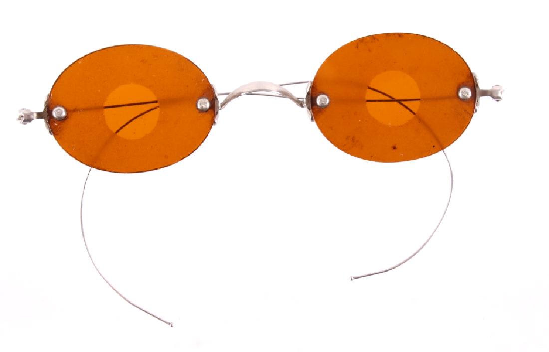 Civil War Era Shooting Glasses c. 1860's: Included in this lot are Civil War era shooting glasses. These glasses feature amber colored frames with a frosted perimeter and clear central area. The clear center area allows for the wearer to focu