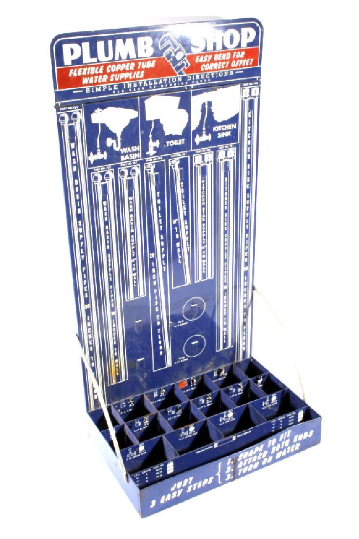 Early Metal Plumb Shop Copper Tube Display Rack: This lot features a Early Metal Plumb Shop Copper Tube Display Rack. The rack features several storage bins, crisp bright graphics, and hanging spots. This rack would be set up in a hardware shop. Thi