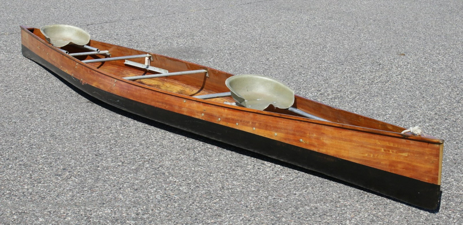 Gene Jensen Wood Strip Racing Canoe: Featured in this lot we have a Gene Jensen wood strip racing canoe originating from the mid to late 20th century. The canoe was manufactured and designed by Jensen Designs, a racing canoe manufacturin