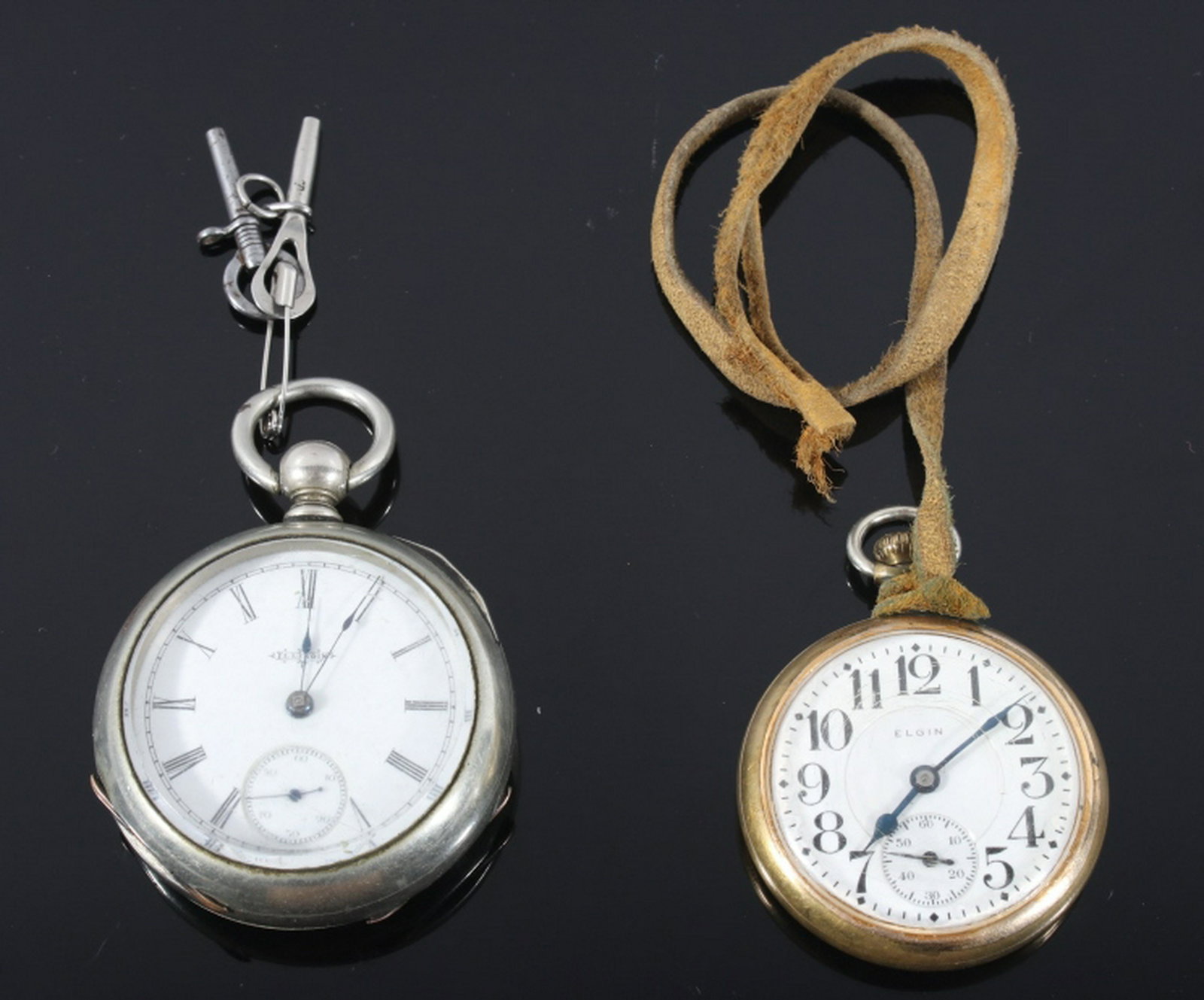 Early 1900 Pair of Elgin & Illinois Pocket Watches: Available in this lot we have a pair of Elgin and Illinois pocket watches originating from the early 20th century. The first of the watches is marked across the face reading "Elgin" with a case made o