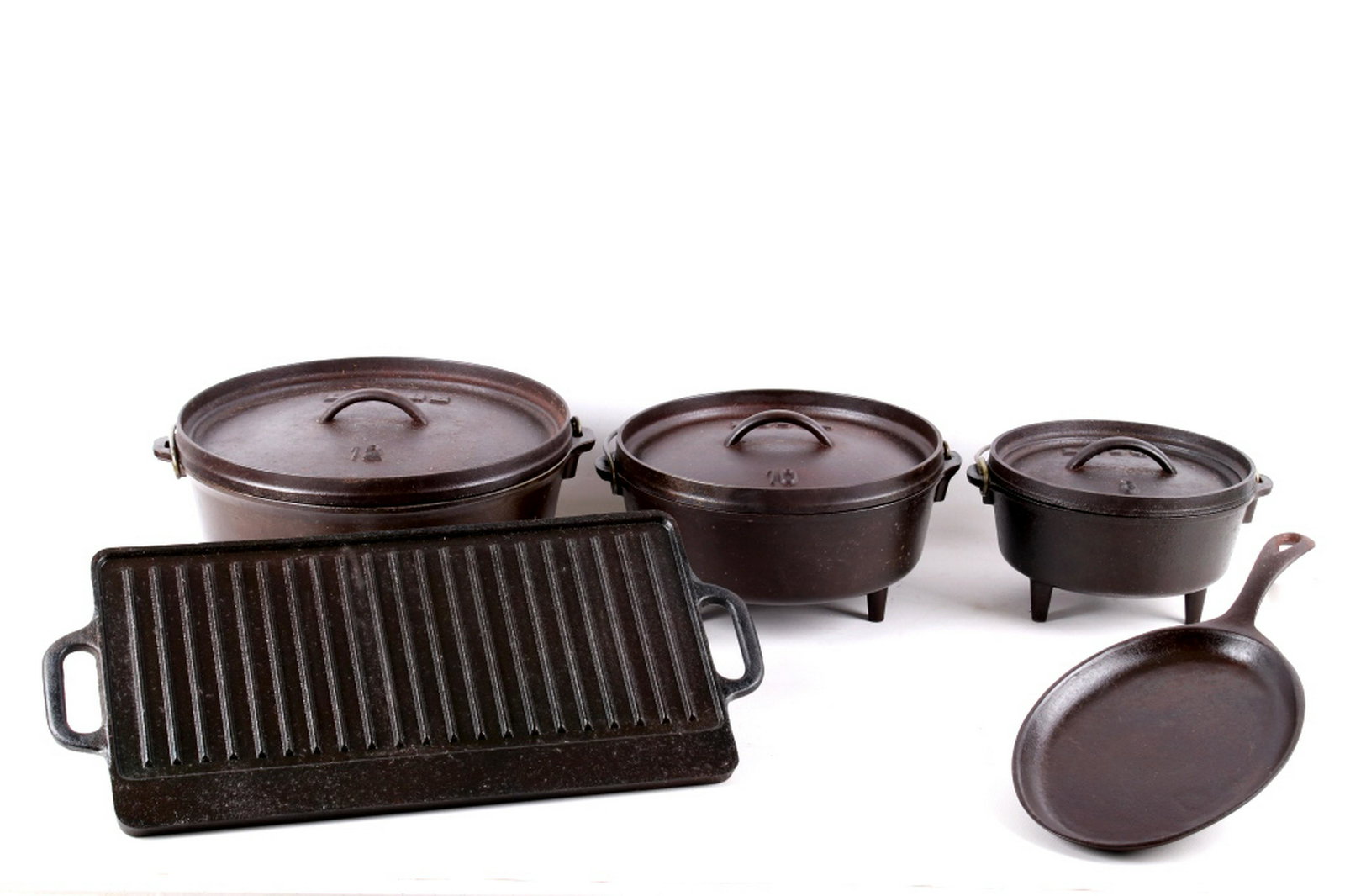 5 piece Lodge Cast Iron Cookware Collection: For your consideration is this 5 piece collection of Lodge cast iron cookware. The set includes 3 camp Dutch ovens (sizes 8, 10 &12) with legs (lids included), a 17" reversible griddle, and a 10" x 7 