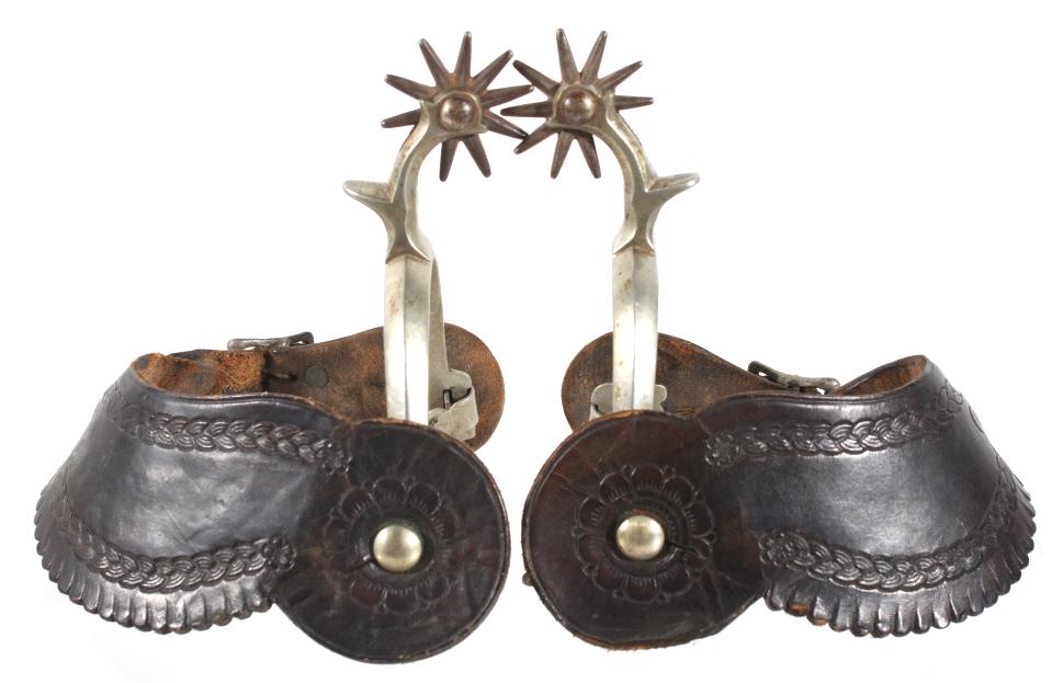 Early August Buermann Nickel-Silver Spurs: Offered in this lot we have a pair of August Buermann nickel-silver cowboy spurs originating from the early 1900's. The spurs shows nickel-silver construction with original leather boot straps and dou