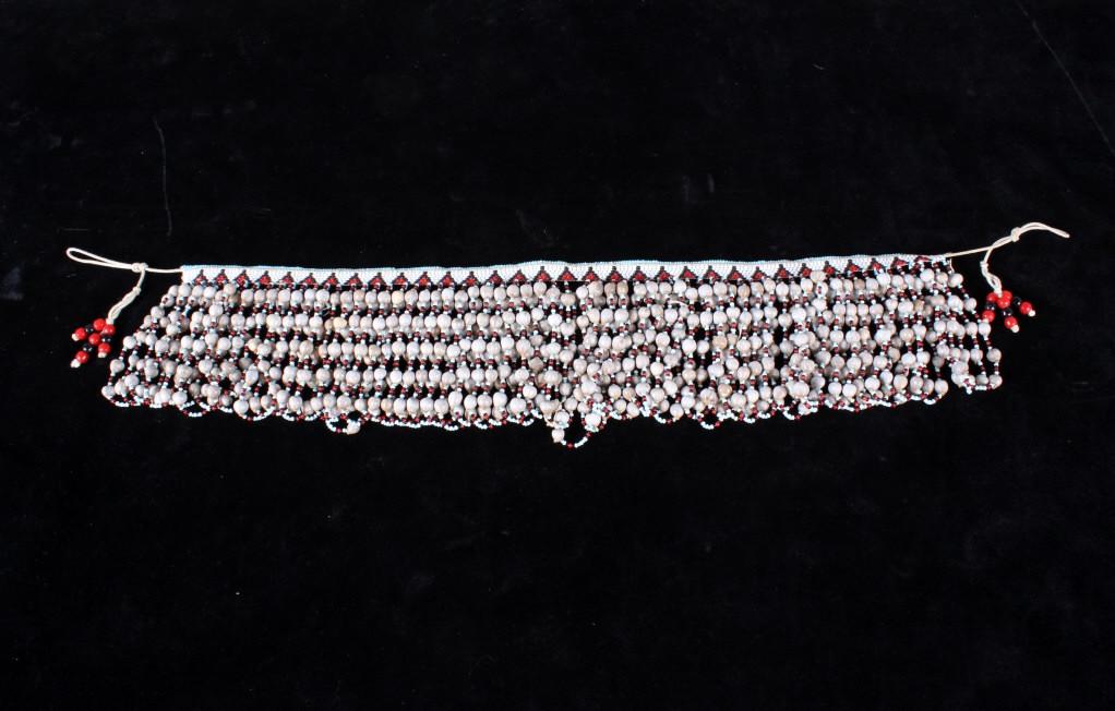 African Coastal Beaded & Shell Belt circa 1930's: The lot features an African Tribal belt from the Coastal people and dating to circa 1930’s. The belt shows a glass trade bead on a thick carpet thread with fringe which shows glass trade beads and s