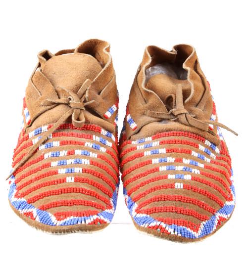 Apache Beaded Hard Sole Moccasins Mid-1900: This is a nice set of beaded moccasins from the Apache Native American Indians dating to the mid-1900’s. The set shows a tanned hide which is sinew sewn at the back and has a medium height ankle wit