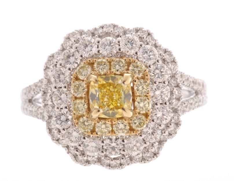 Art Nouveau Fancy Yellow & VS2 Diamond 14K Ring: This is a remarkable vintage estate Fancy Yellow Diamond and White Diamond 14K white gold ring. The ring shows a gorgeous cushion cut center Diamond showing a Fancy Light Yellow coloring with SI-1 cla
