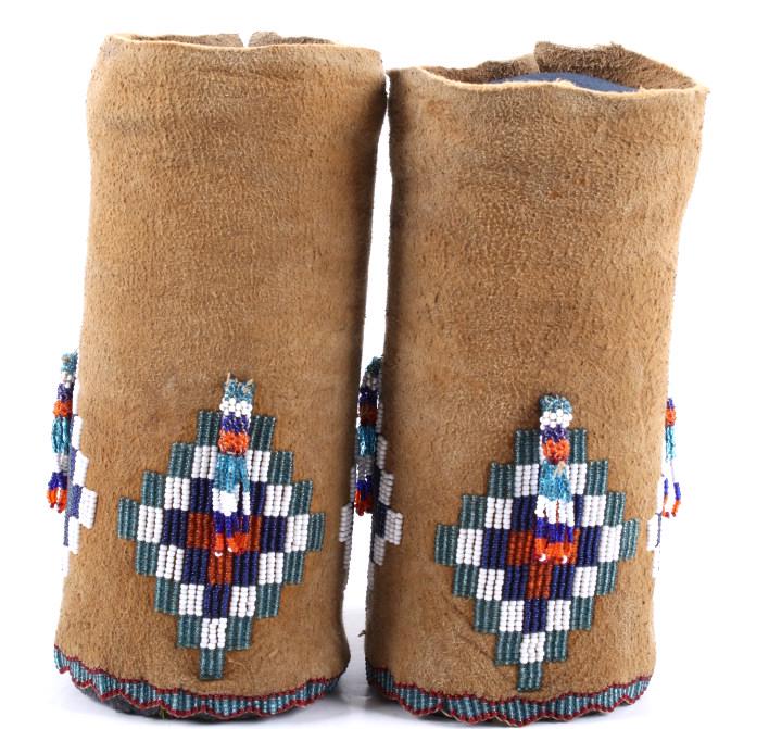 Apache Beaded Legging Cuffs c.1900: This is an excellent set of Apache Beaded Legging Cuffs dating to the early 1900’s. The set shows an Indian tanned Buffalo hide construction that is hide sewn and has a cylindrical shape, typical of