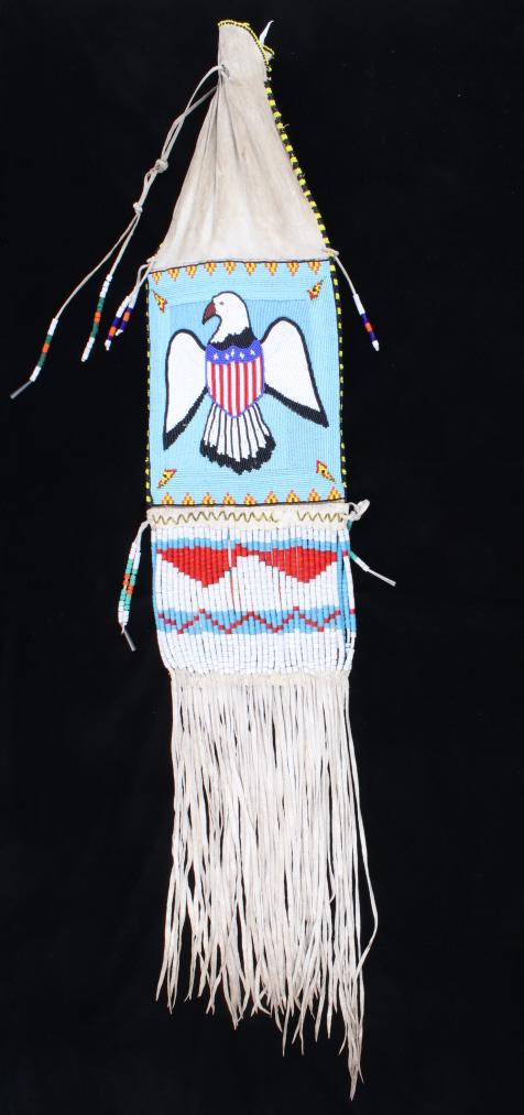 Sioux Fully Beaded Patriotic Pipe Bag c. 1960's: The lot features a fine vintage fully beaded pipe bag from the Sioux Native American Indians dating to circa 1960’s Reservation era. The bag shows an Indian tanned hide construction with glass trade