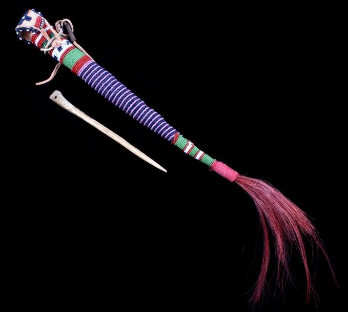 Kiowa Fully Beaded Awl Case & Awl: The lot features a fully beaded awl case and awl attributed to the Kiowa Native American Indians. The piece shows a parfleche construction which has been covered in Indian tanned hide and accented by 