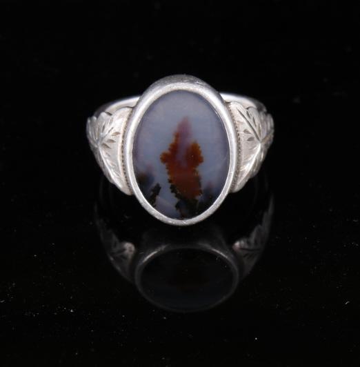 Signed Montana White Moss Agate Sterling Ring: This lot features a signed Montana moss agate, and sterling silver ring. Moss agate is a form of chalcedony which includes minerals of a green color embedded in the stone, forming filaments and other