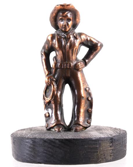 Small Copper Cowboy Statue: In this lot we have a small copper cowboy statue. The copper statue is on a round piece of birch wood painted a dark brown. The copper statue is connected to the birch wood by a flat head screw. This 