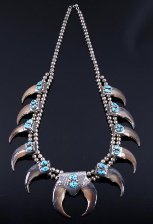 Signed Navajo Bear Claw & Turquoise Necklace: Featured in this lot we have a Navajo Native American sterling silver squash blossom necklace with turquoise and bear claws signed by Julia Etsitty. The necklace displays 12 large bear claws with wond