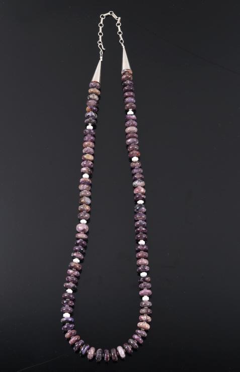 Navajo Sterling Silver & Sugilite Beaded Necklace: Included in this lot we have a Navajo Native American sterling silver and sugilite beaded necklace. The necklace shows 82 beads of sugilite beads with white coral and sterling silver beads between the